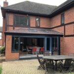 solid roof conservatory with bi fold doors